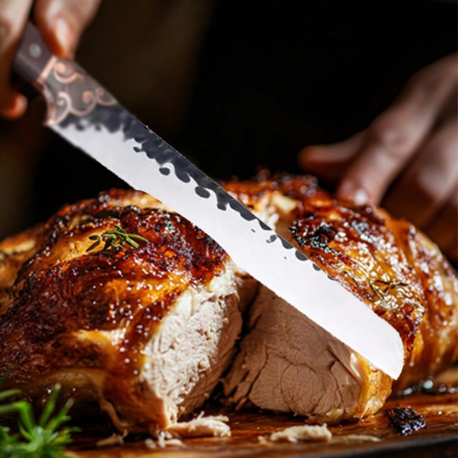 Knife alongside BBQ ribs and roast on grill platter